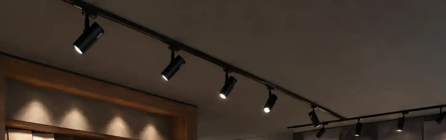 Track rail band across a materials showroom ceiling
